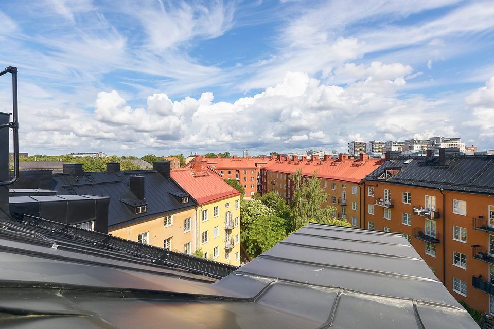 Vy från takterrassen ut över omgivande hustak och trädkronor.